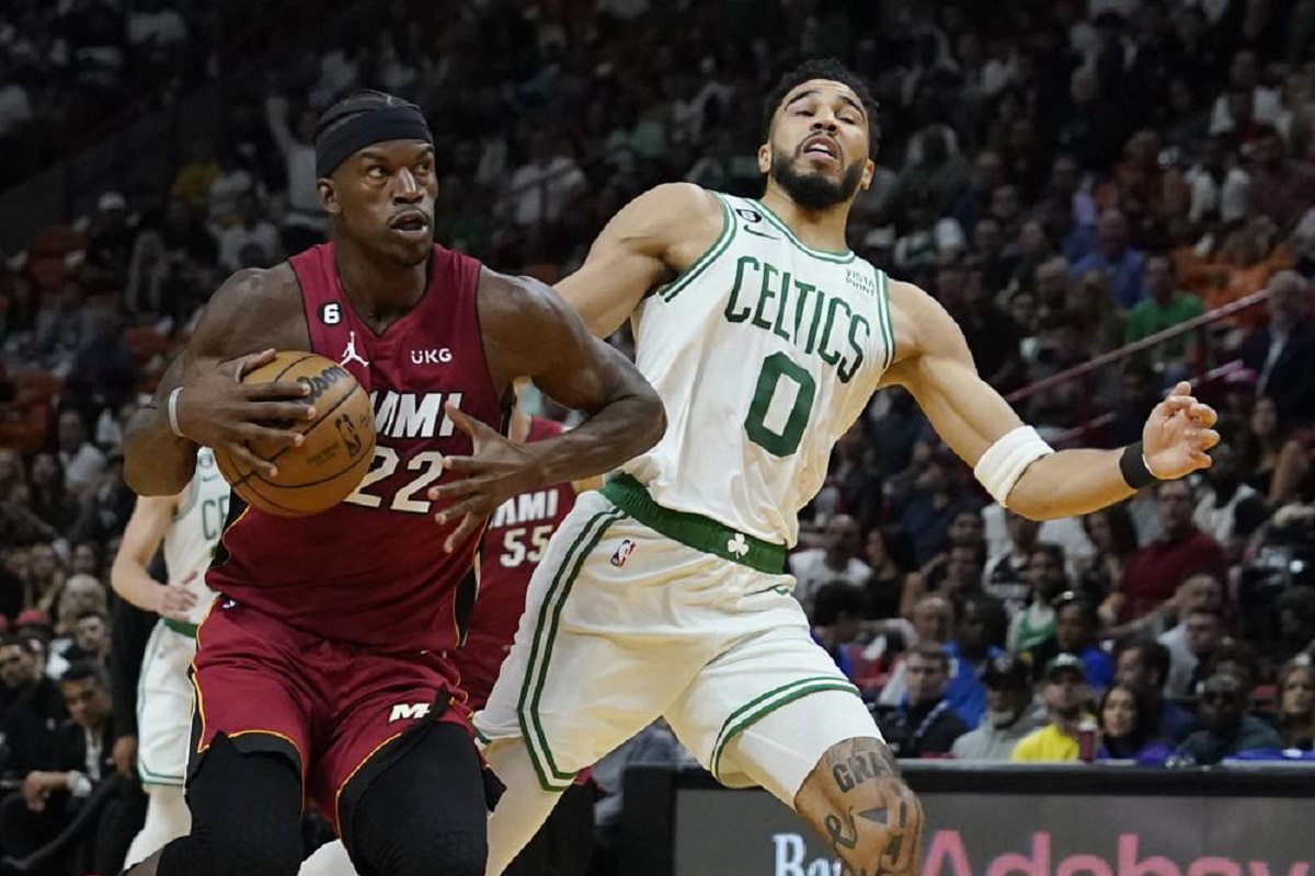 Miami Heat forward Jimmy Butler (22) drives to the basket as Boston Celtics forward Jayson Tatum (0) defends during the first half of an NBA game Friday, Oct. 21, 2022, in Miami. 