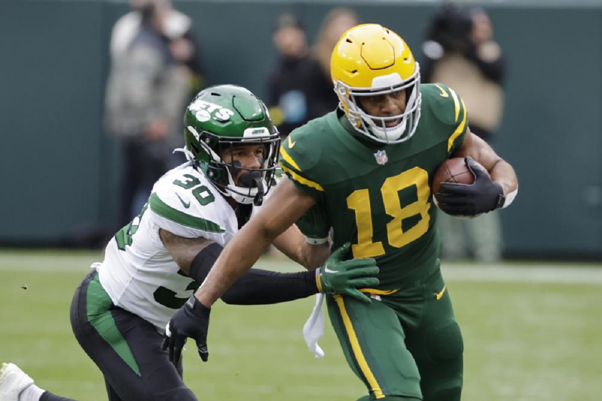 New York Jets cornerback Michael Carter II (30) tackles Green Bay Packers wide receiver Randall Cobb (18) during the first half of an NFL football game Sunday, Oct. 16, 2022, in Green Bay, Wis. 